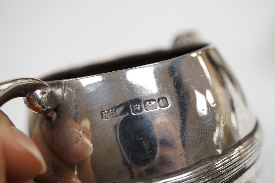 An Edwardian silver three piece bachelor's tea set, with reeded band, by Henry Stratford Ltd, Sheffield, 1909, gross weight 19oz.